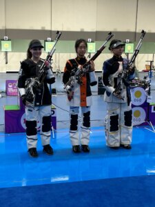 Three women holding air rifles on the range.